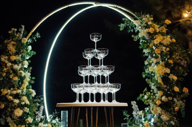 Champagne glasses standing in a tower at the party