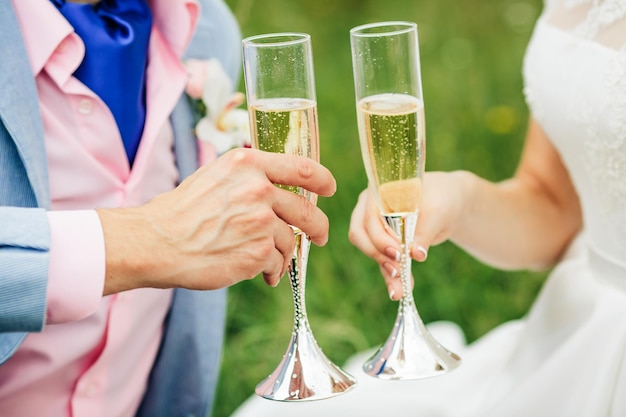 Champagne glasses in their hands the bride and groom