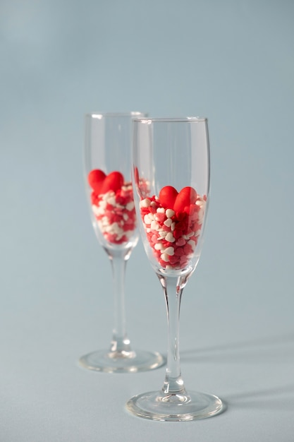 champagne glasses with red heart shaped sugar candy.