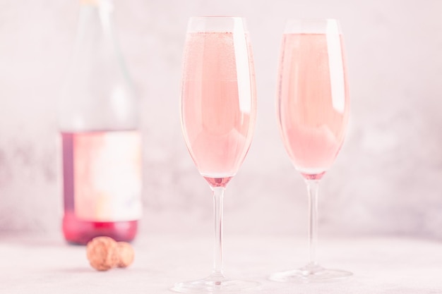 Champagne or wine in glasses on light background