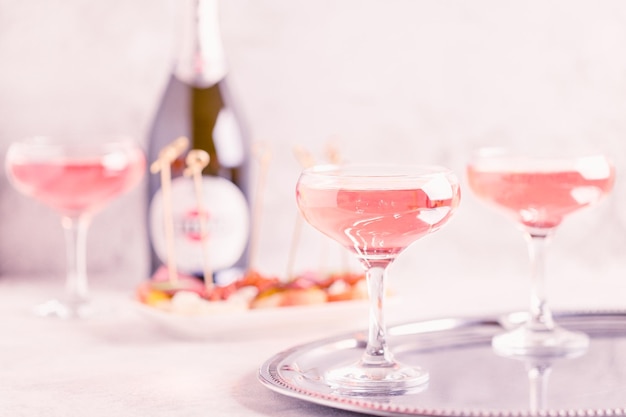 Champagne or wine in glasses on light background