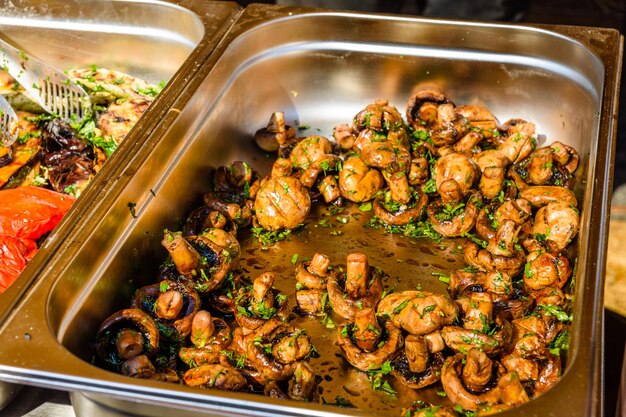 Champignons prepared on a barbecue grill in metal tray