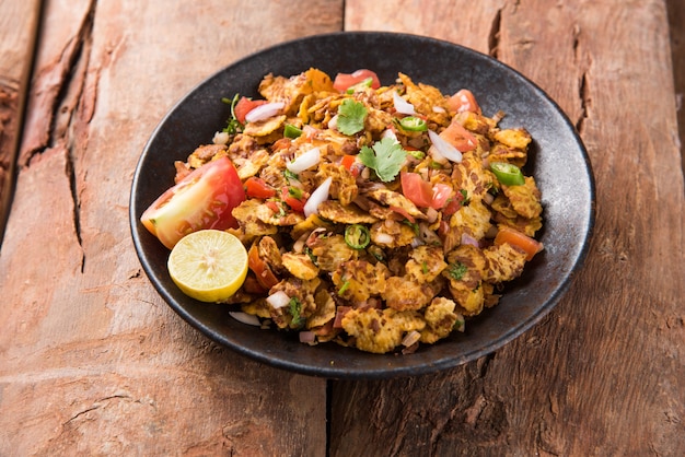 Chana chor jor garam - Indian roadside spicy chat or snack food, served in a plate or bowl over colourful or wooden background. Selective focus