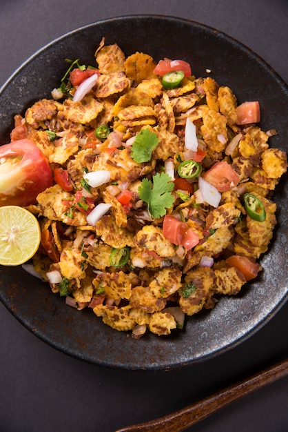 Chana chor jor garam - Indian roadside spicy chat or snack food, served in a plate or bowl over colourful or wooden background. Selective focus