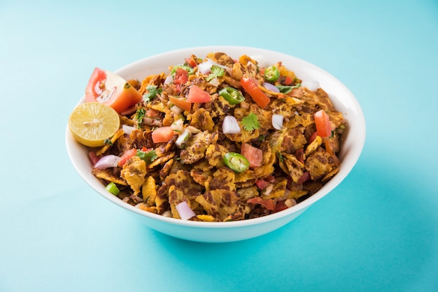 Chana chor jor garam - Indian roadside spicy chat or snack food, served in a plate or bowl over colourful or wooden background. Selective focus