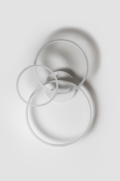 Chandelier in the form of three rings against a white ceiling