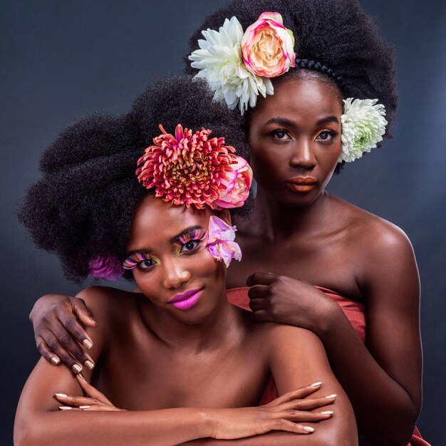 Change is beautiful Cropped shot of two beautiful women posing together with flowers in their hair