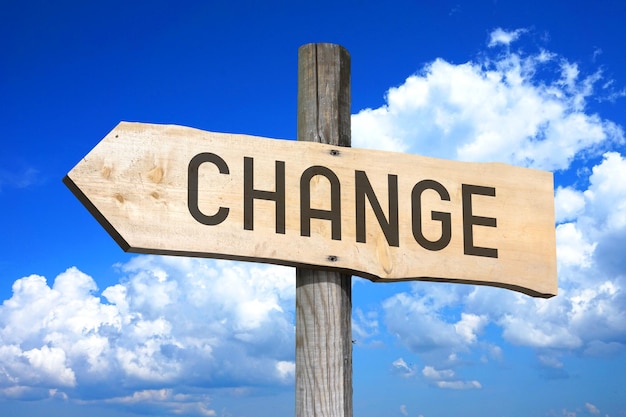 Change wooden signpost with one arrow sky with clouds in background