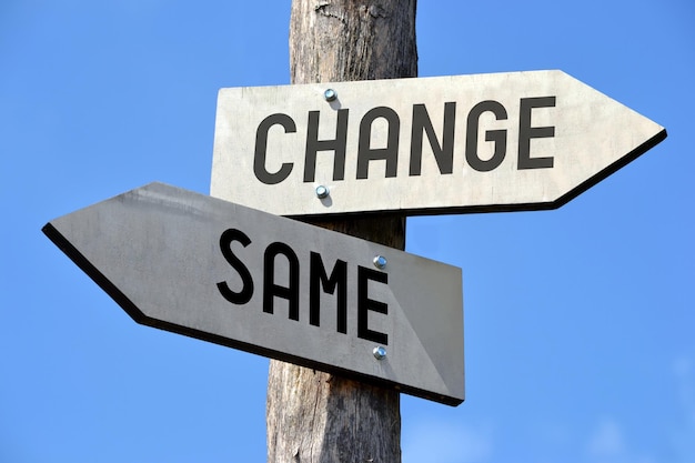 Changes wooden signpost with two arrows