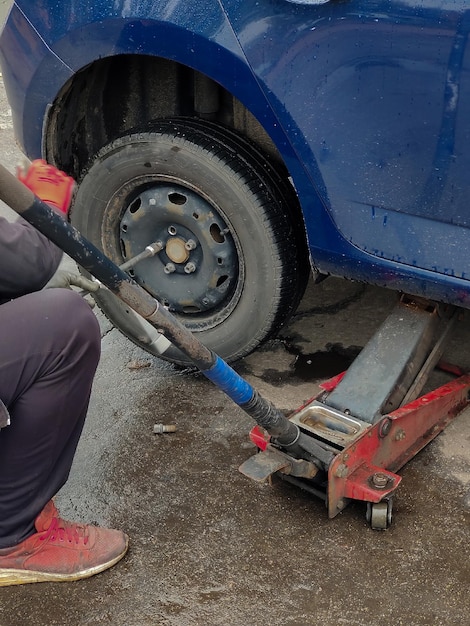 Changing a wheel on a car jack at a car service station