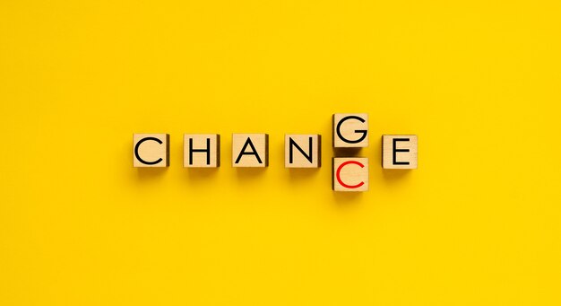 Changing the word Change into Chance Wooden dices spelling words Change and Chance