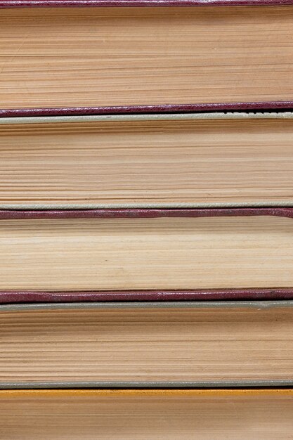 Chaotic stack of old books background, selective focus