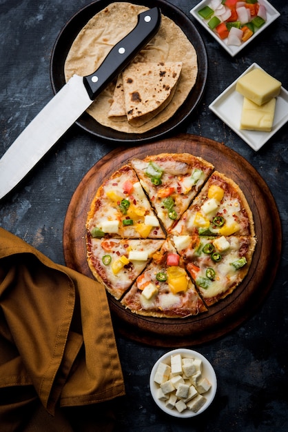 Chapati Pizza made using leftover Roti, Paratha with Cheese, vegetables, paneer and Sausage