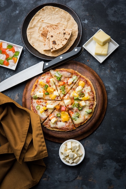 Chapati Pizza made using leftover Roti, Paratha with Cheese, vegetables, paneer and Sausage