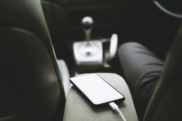 Charge the battery phone in car. Place the mobile smart phone in the car.