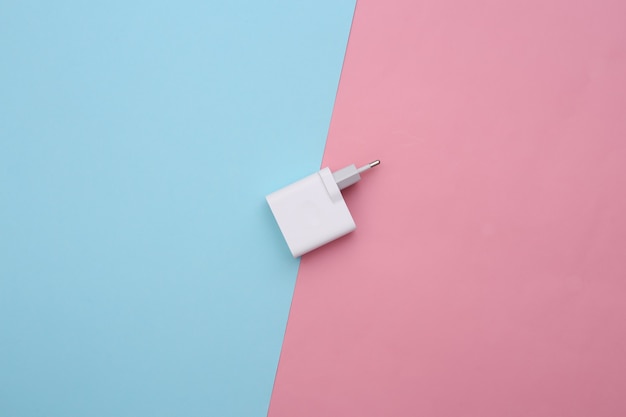 Charger adapter on a blue-pink pastel background. 