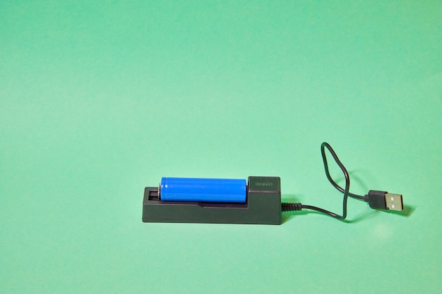 Charger for blue  battery on green background