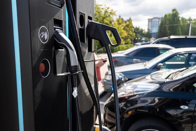 Charging the batteries of an electric car on a city street refueling for cars emobility charging an