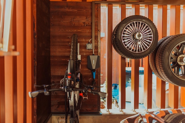 Charging an electric bike in the garage of a modern house High quality photo