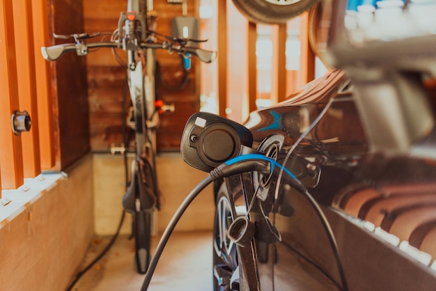 Charging a electric car in the garage of a modern house High quality photo