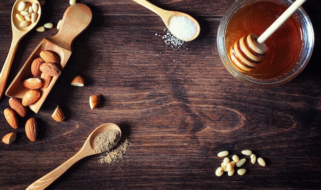 Charlotte with apples and nuts. Preparation of apple baking with nuts and honey. Dessert baked goods from apples and nuts with honey on a wooden table.