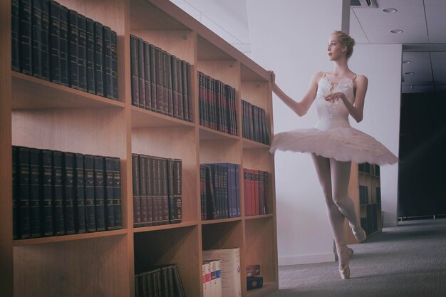 a charming ballerina went to the library to choose a new book during a break