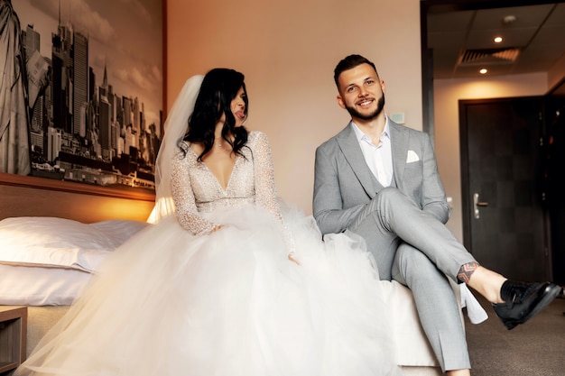 Charming bride and groom in their bedroom