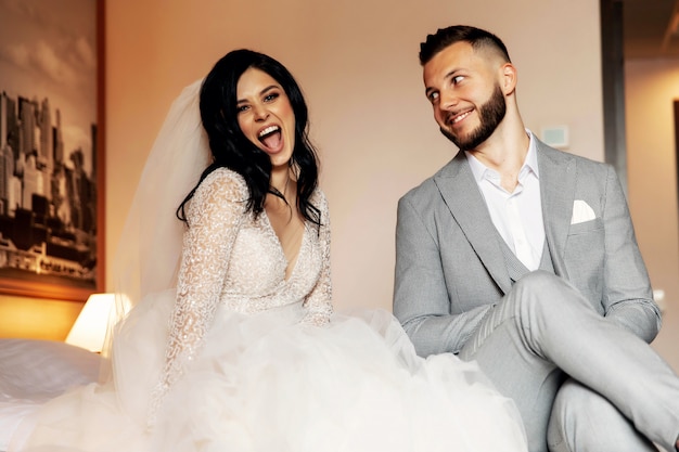 Charming bride and groom in their bedroom