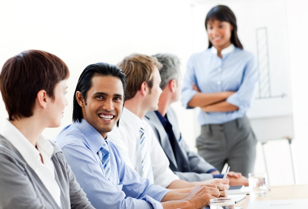 Charming businessman looking at the camera in a meeting 