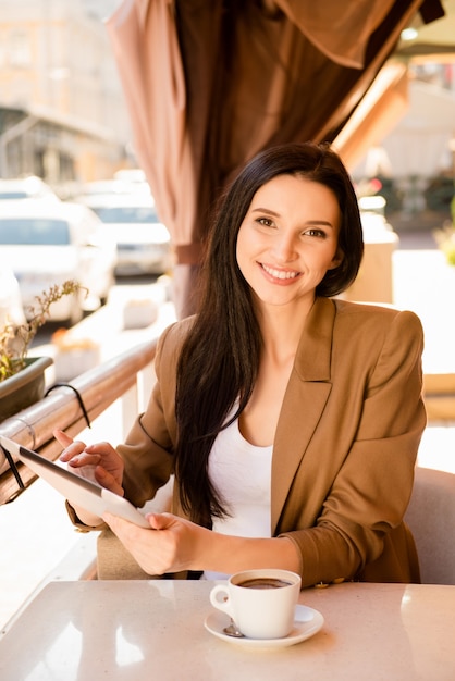 Charming businesswoman sitting in a cafe