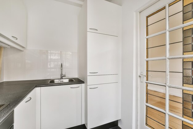 Charming design of a small kitchen with a black countertop