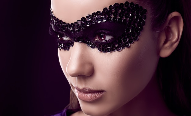 Charming elegant brunette woman in sequins mask