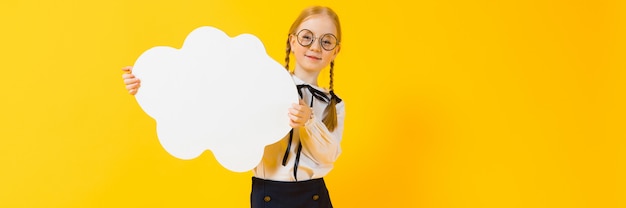 A charming girl in round transparent glasses is holding a white cloud in her hands. 