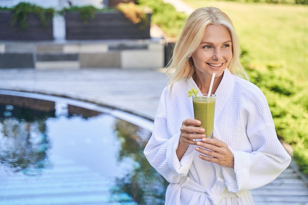 Charming happy woman spending time in the spa resort hotel on the vacation