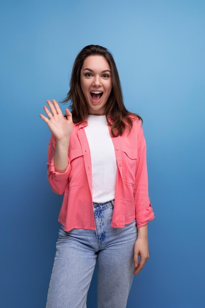 Charming informal brunette woman with hair below her shoulders posing as a model