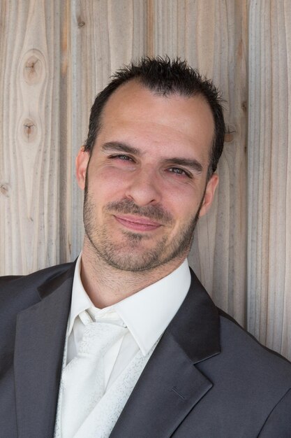 Charming man with a shirt under wooden background