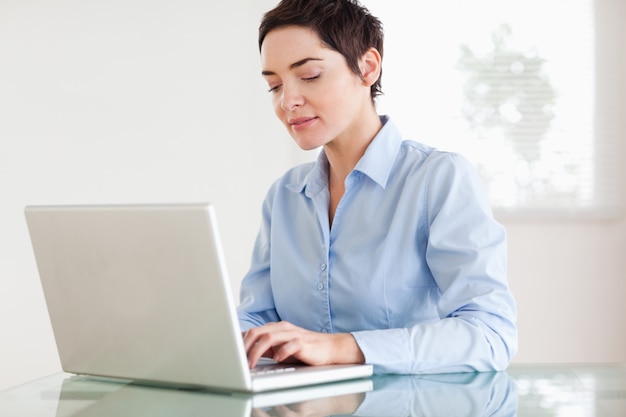 Charming short-haired businesswoman with a laptop