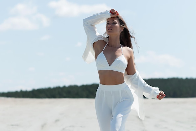 Charming woman standing on beach