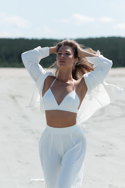 Charming woman standing on beach