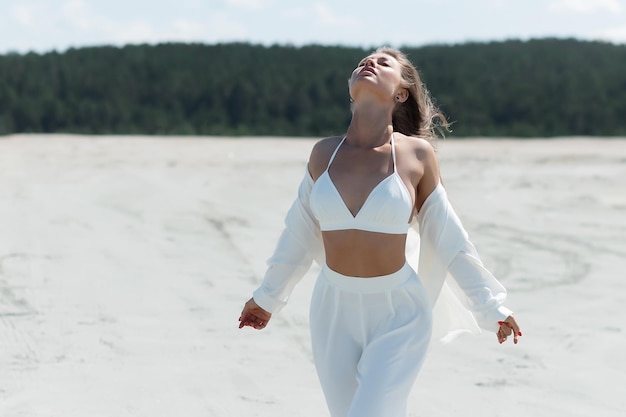 Charming woman standing on beach