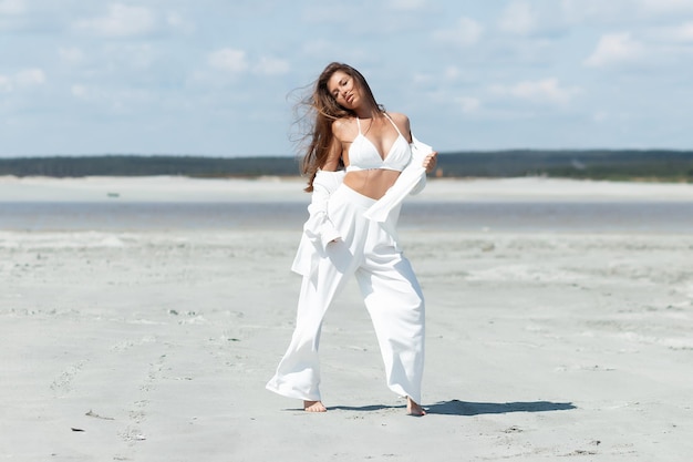 Charming woman standing on beach