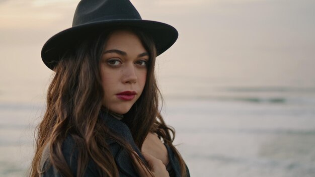 Charming woman standing coast overcast day close up portrait of calm brunette