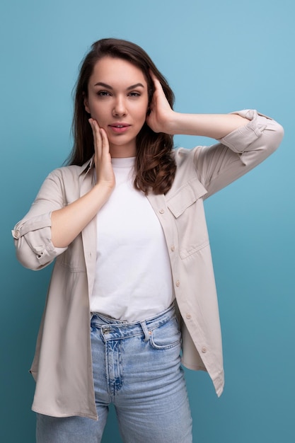 Charming young brunette female adult in casual shirt