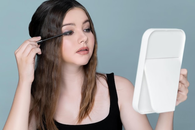 Charming young brunette girl posing gesture for eye cosmetic concept