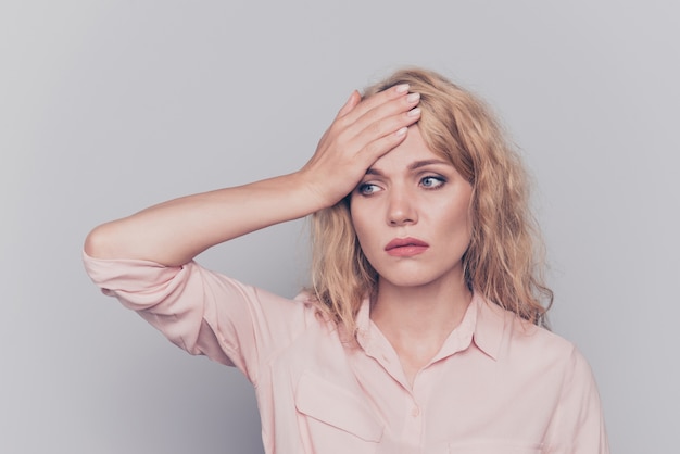 Charming young girl suffering from fever touching forehead