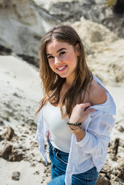 Charming young girl travels in a sandy canyon quarry and enjoys summer vacation