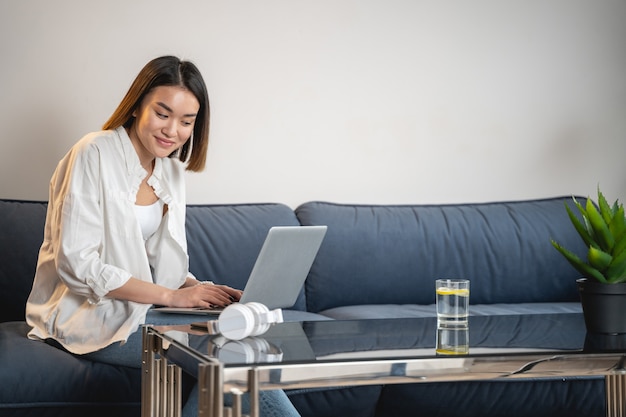 Charming young girl using laptop computer