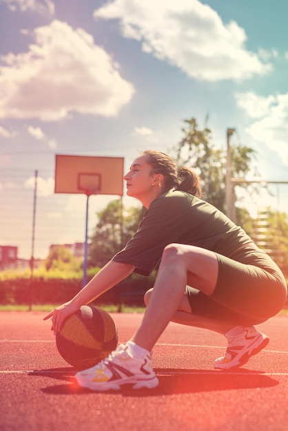 Charming young woman wear sport cloth with a basketball is resting after a workout summer active day for sport