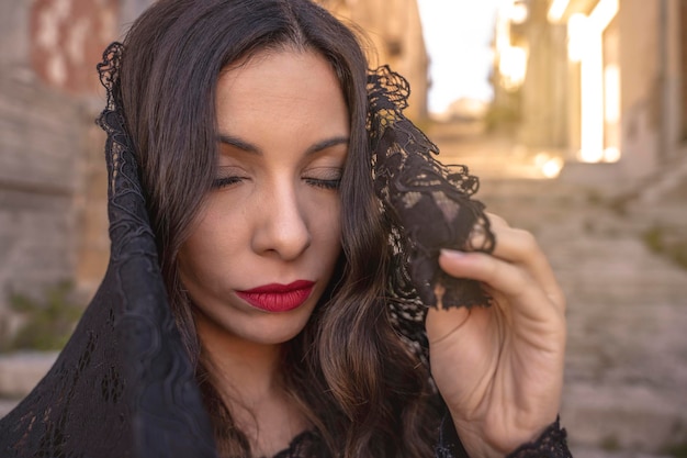 Charming young woman with closed eyes in a typical Sicilian village