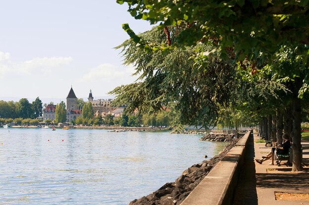 Chateau Ouchy in Geneva Lake promenade in Lausanne, Switzerland. People on the background